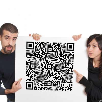 Surprised boy and girl holding a panel with qr code